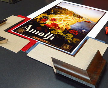 Print of Amalfi laying on counter with custom framing materials surrounding it during the design process.